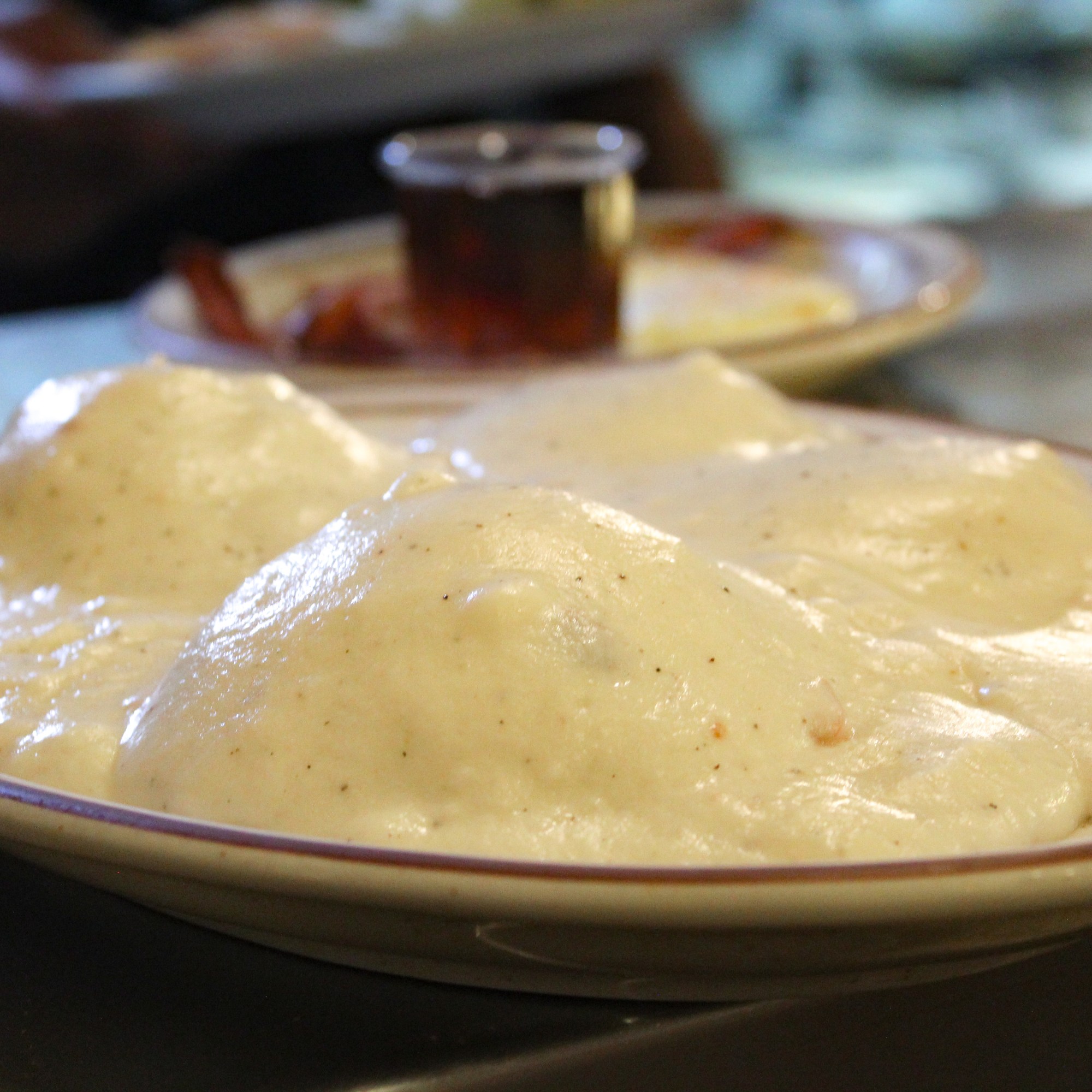 buiscuits and gravy fluffy muffin shaped buiscuits topped with white bacon gravy, creamy and delicious